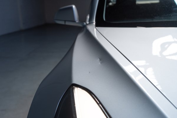 Passenger side front fender touched up scratch and dent