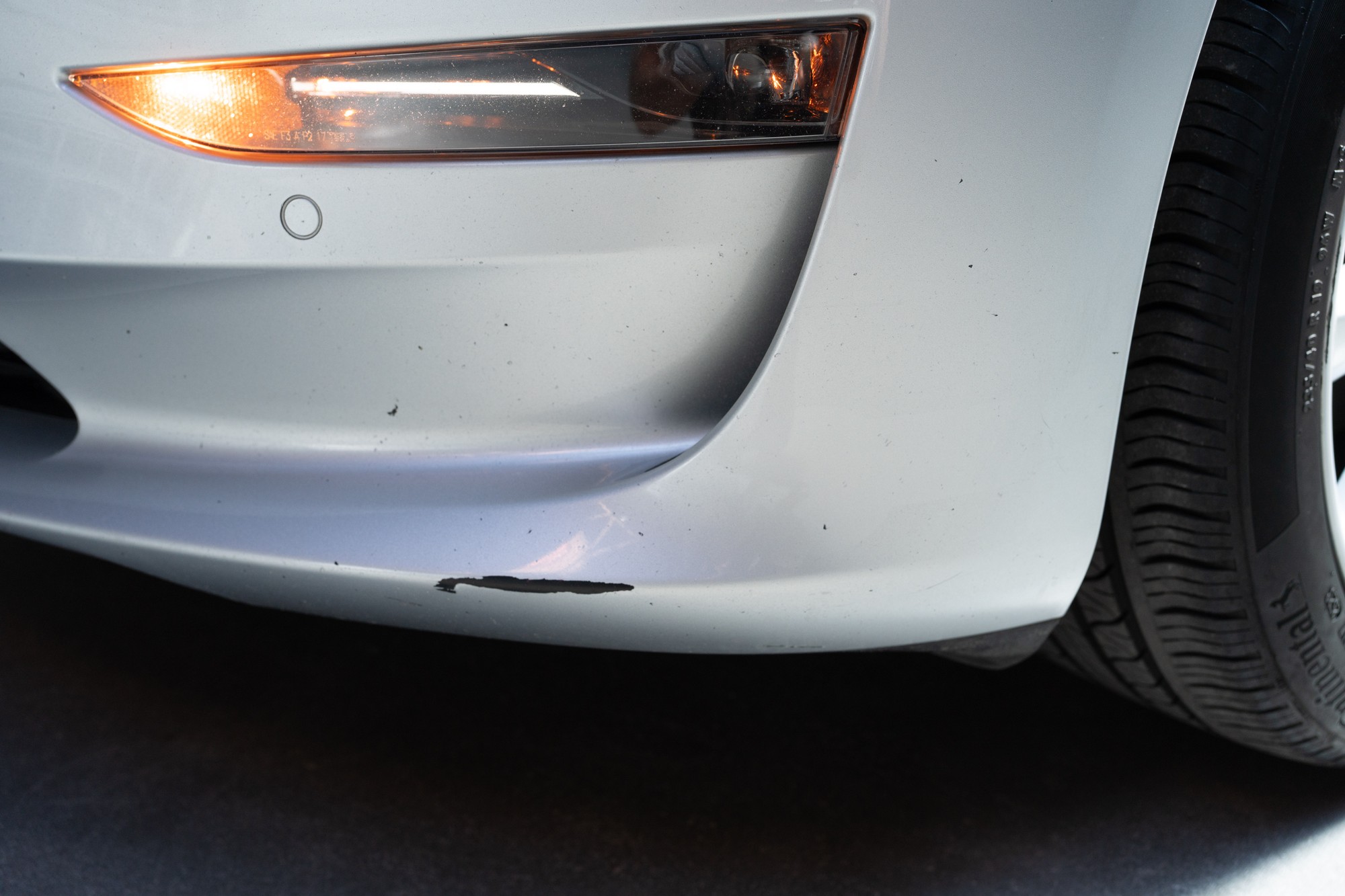 Scrape on lower portion of driver side front bumper