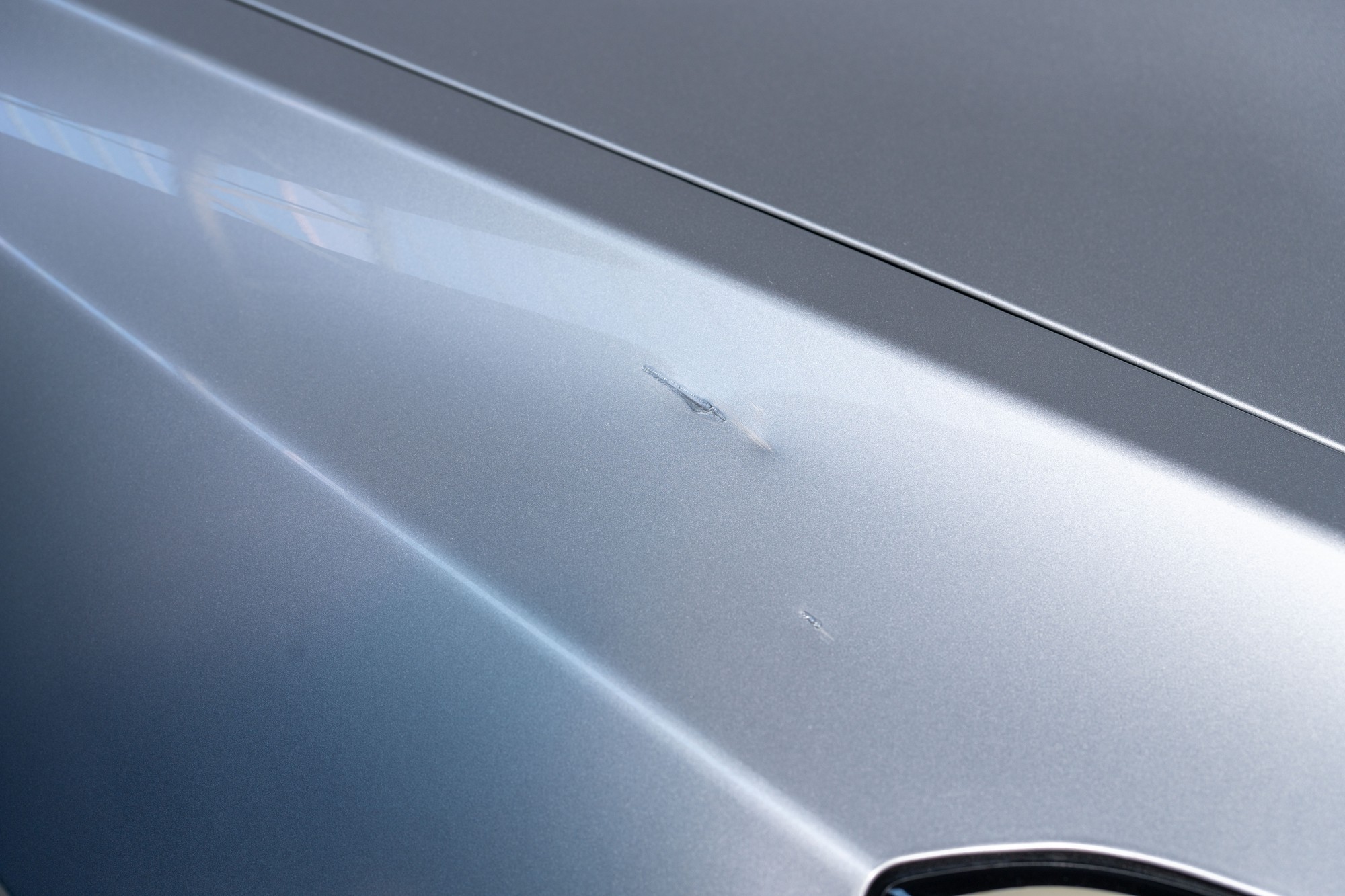 Passenger side front fender touched up scratch and dent