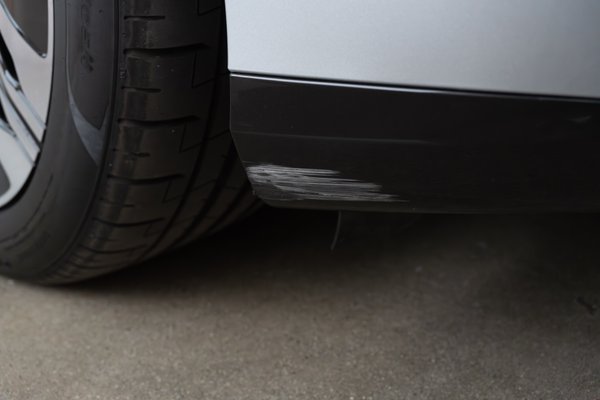 Scrape on lower passenger side front bumper. Low visibility location